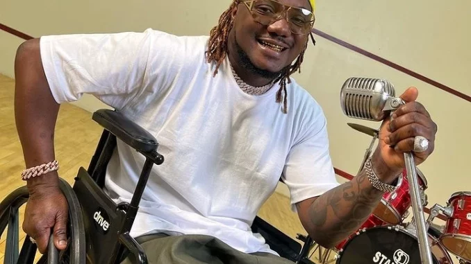 Rapper, CDQ steps in a Wheelchair few weeks after being involved in an accident
