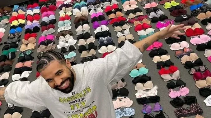 Rapper, Drake poses with all the bras he collected from his tour